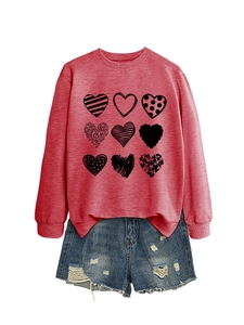Detail of pink sweatshirt with nine black heart prints and love text on white background