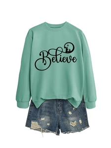 Detail of mint green sweatshirt with Believe lettering and ribbed cuffs on white background