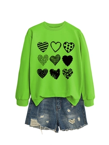 Detail of neon green crewneck sweatshirt with nine black heart prints and LOVE text