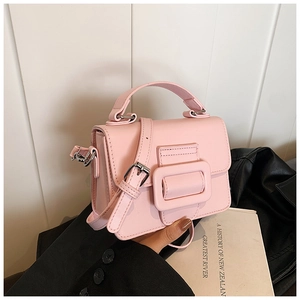 Dettaglio borsa a tracolla in pelle PU rosa con fibbia decorativa e tracolla regolabile