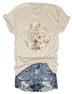 Detail of wildflower wreath print on a beige casual T-shirt with denim shorts
