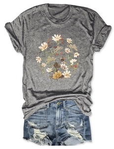 Flat lay of a grey crew neck T-shirt featuring a floral wreath print with denim shorts