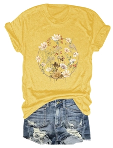 Flat lay of yellow t-shirt with floral wreath print and distressed denim shorts detail