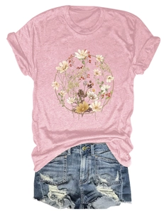 Detailed flat lay of pink short sleeve T-shirt with floral print and ripped denim shorts