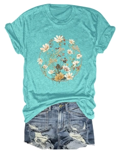 Flat lay of a turquoise t-shirt with vintage floral wreath and distressed denim shorts