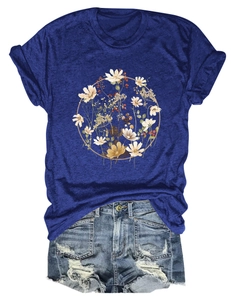 Close-up of floral wreath print on navy blue short sleeve t-shirt with denim shorts