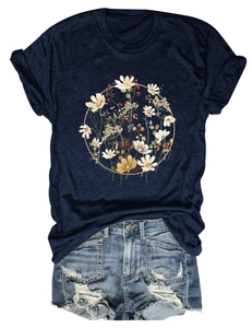 Detail of floral wreath print on navy short sleeve T-shirt with distressed denim shorts