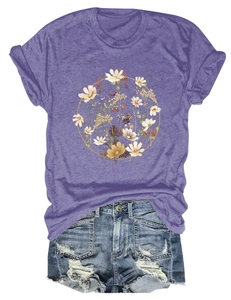 Detail of purple T-shirt with floral wreath pattern paired with ripped denim shorts
