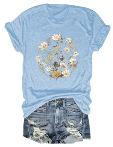 Close-up of casual light blue T-shirt with floral wreath print and ripped denim shorts