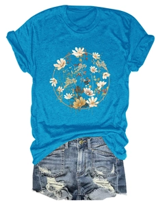 Flat lay of lake blue t-shirt with floral wreath and distressed denim shorts outfit