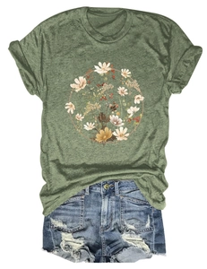 Flat lay of moss green t-shirt with floral wreath print and distressed denim shorts
