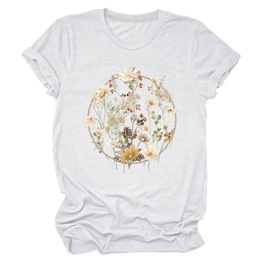 Detailed view of white T-shirt featuring a vintage floral wreath and rolled-up sleeves