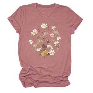 Detail of floral wreath print on pink crew neck T-shirt with rolled sleeve cuffs