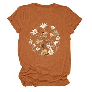 Close-up of floral wreath print on a rust red cotton t-shirt with a vintage aesthetic