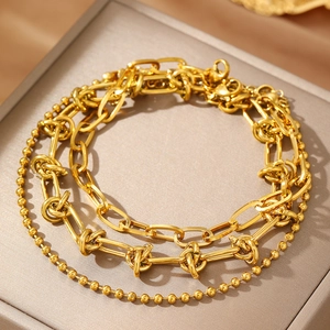 Three-layer gold stainless steel chain bracelet set with knot elements in a jewelry box