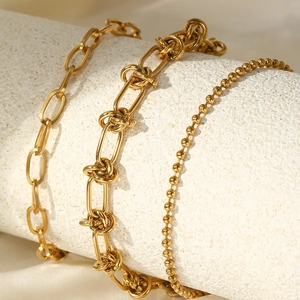 Gold stainless steel triple-layered punk bracelet featuring curb and knot chain links