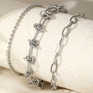 Detailed close-up of triple-layered stainless steel knot and punk cuban chain set