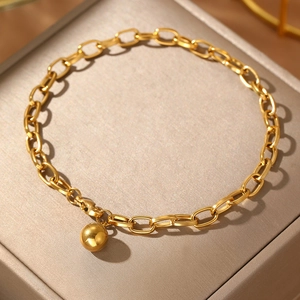 Gold stainless steel link bracelet with solid round bead pendant on jewelry box