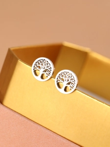 Detailed shot of titanium tree of life stud earrings on a golden jewelry box display