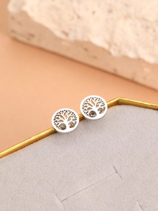 Detailed close-up of silver Tree of Life earrings on a premium jewelry display box