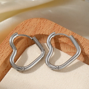 Boucles d'oreilles cœur en acier inoxydable argenté sur présentoir en bois minimaliste