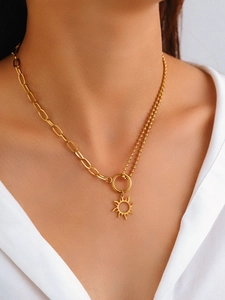 Golden sun totem pendant necklace with mixed chain design shown on model neck