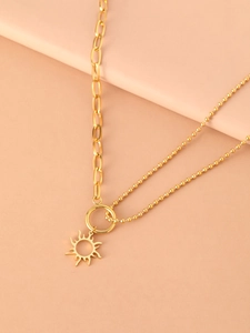 Detailed close-up of a 18K gold plated hollow sun pendant on a dual-style link chain