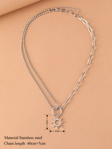 Detail of hollow sun pendant with asymmetric bead and link chain in silver finish