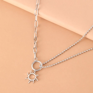 Minimalist stainless steel necklace featuring a hollow sun totem pendant and asymmetric chain