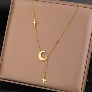 Minimalist stainless steel gold-plated necklace with moon and star fringe pendants on a box