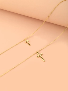 Detail of two gold-plated stainless steel necklaces with hollow cross pendants