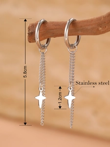 Detail view of 5.8cm stainless steel drop earrings with star pendants on wooden branch