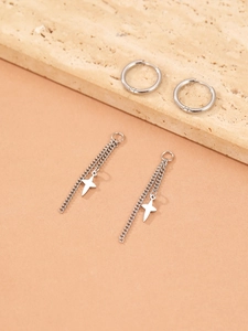 Detailed view of silver stainless steel hoop earrings with hanging star chain pendants