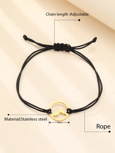 Detail of adjustable black rope bracelet with a 1.8cm golden mountain peak charm