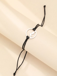 Macro view of woven black cord bracelet with silver mountain cutout charm on display