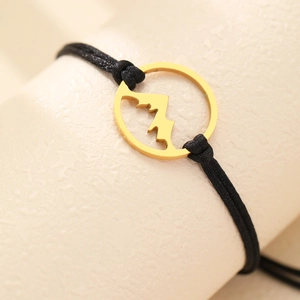 Adjustable black rope bracelet featuring a golden stainless steel mountain peak pendant