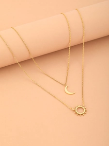 Detailed view of titanium steel layered necklace with sun and crescent moon pendants