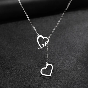 Punk style silver double heart pendant necklace with love script on black background
