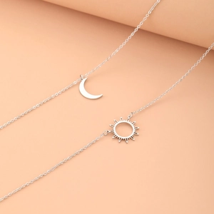 Double-layer stainless steel necklace featuring sun and moon pendants on a fine O-chain