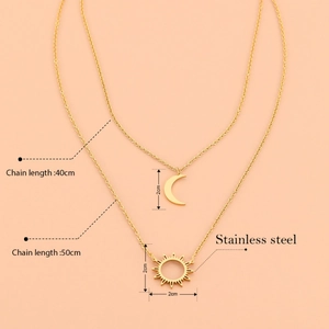 Double-layered stainless steel necklace featuring sun and moon pendants on a warm background