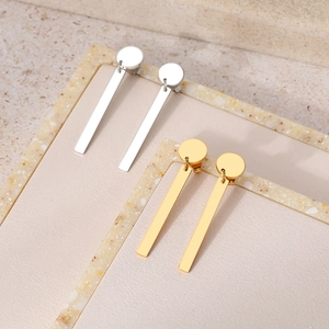 Minimalist stainless steel long tassel earrings in gold and silver set on marble