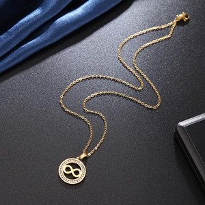 18k gold plated infinity pendant necklace with micro-pave cubic zirconia on a black backdrop
