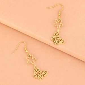 Elegant gold butterfly and flower drop earrings with intricate hollow design on light pink base