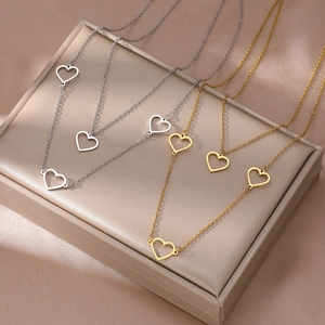 Set of gold and silver heart necklaces with hollow pendants on a minimalist O-chain