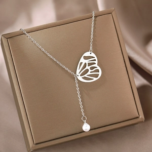 Elegant silver butterfly Y-necklace with round pearl pendant on a jewelry gift box