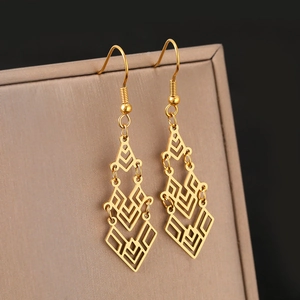 Bohemian gold leaf earrings with tiered geometric hollow design on a display stand