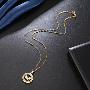 Elegant gold butterfly pendant necklace with zircon crystals on a classic link chain