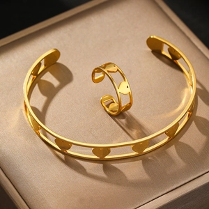 Adjustable golden stainless steel open bracelet and ring set with hollow heart pattern