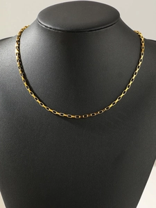 Detail of a gold box chain necklace displayed on a premium black leather jewelry bust