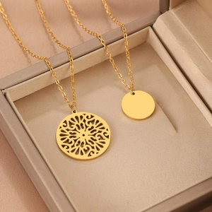 Vintage gold layered necklace featuring hollow mandala disc and solid polished pendant